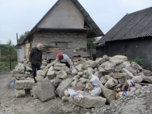 Searching for headstones among the rubble of the old building